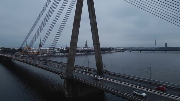 Many Cars Passing By Vansu Bridge in Gloomy Winter City of Riga Latvia alt