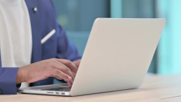 Close Up of Hands of African Businessman Typing on Laptop alt