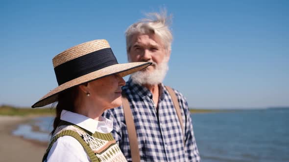 Happy Elderly Retirement Couple Having a Rest Together on the Seashore or Ocean Closeup Enjoying a alt