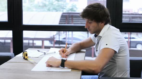 A civil engineer designs and works on drawings and analyzes the structure of a project. alt