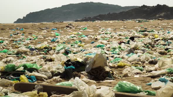 Sad scene with lot of garbage scattered on Vietnamese beach. Static, low POV alt