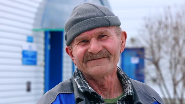 Old Toothless Man of Retirement Age Looks Into Camera and Laughs