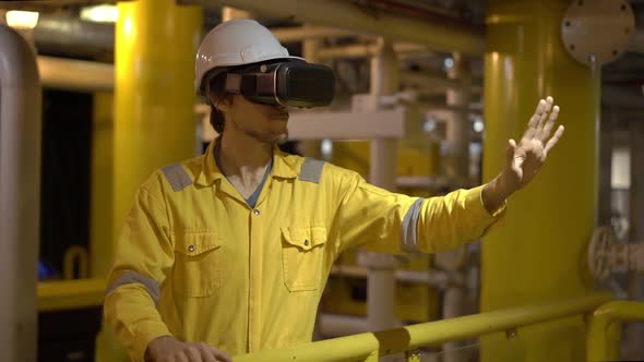 Young Man in a Yellow Work Uniform in Industrial Environment,oil Platform or Liquefied Gas Plant alt
