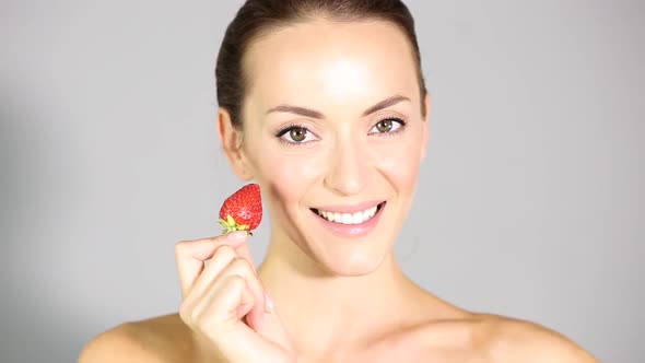 Young Woman Eating Strawberry