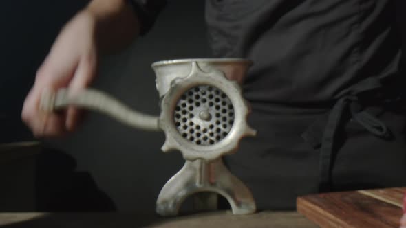 Man Using Manual Meat Grinder alt