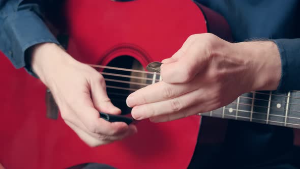 Male Hands Take Pick Out of and Start Playing Guitar