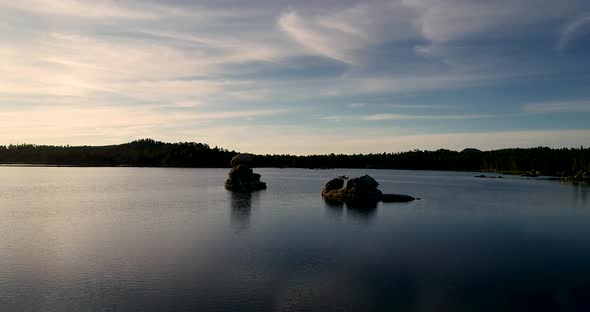 A tiny boat appears at the end of this beautiful clip filled with reflections of gold, teal, orange alt