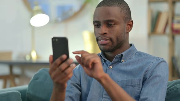 Young African Man Loss on Smartphone alt