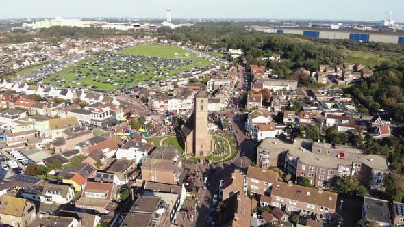 Aerial 4k footage, panning the horizon of the small coastal town of Wijk aan Zee in North Holland alt