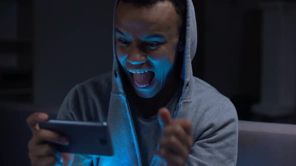 Extremely Emotional Black Guy Winning Video Game on Smartphone, Overreacting alt