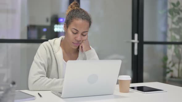 Tired African Woman Taking Nap While Sitting in Office with Laptop alt