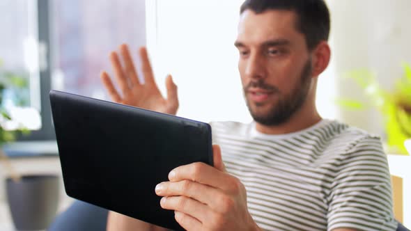 Happy Man with Tablet Pc Having Video Call at Home alt