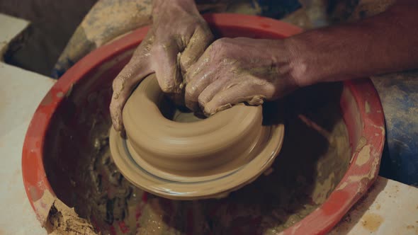 Top View of Manly Male Hands Making Clay Bowl, Using Wheel in Workshop alt