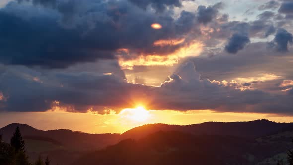 Colorful Clouds in Fast Motion Over Green Hilly and Forest Landscape in Summer alt