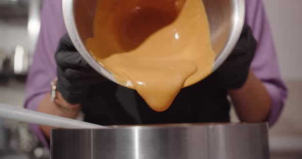 A Professional Confectioner Pours Sweet Caramel Into The Confectionery And Decorates The Cake.