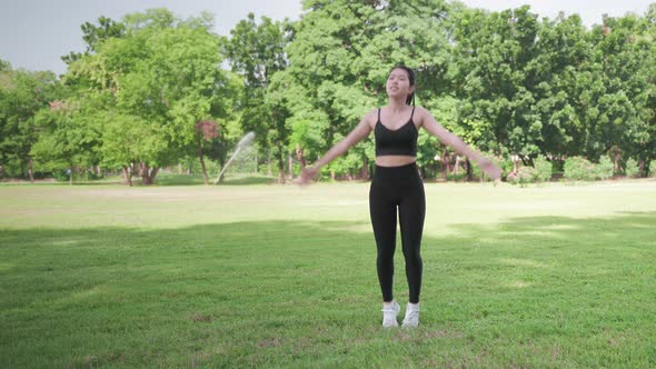 beautiful asian woman Jumping exercises in the park