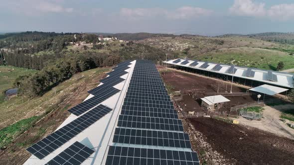 Aerial footage over chicken farm covered with solar panels in northern Israel alt