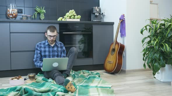 Man studying online in internet from home and chatting with friends during self isolation alt