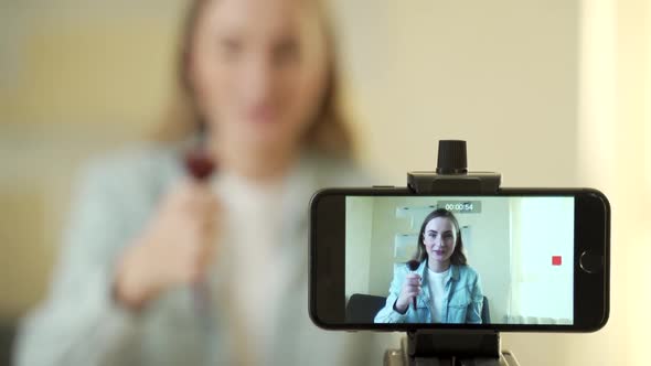 Female Blogger Making a Video for Her Beauty Blog on Cosmetics. alt
