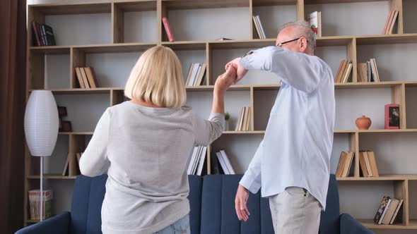Senior Couple Dancing at Home in Living Room Beautiful Romantic Pensioners alt