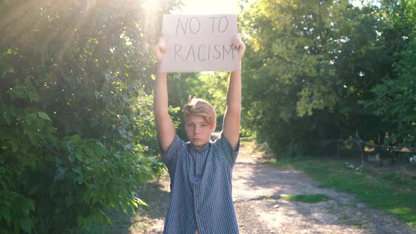 Young Caucasian Teenager Man Blue Shirt Stands Holds Outstretched Arms Above His Head a Corton Box alt