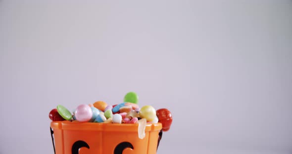 Halloween bucket filled up with various confectioneries 4k alt