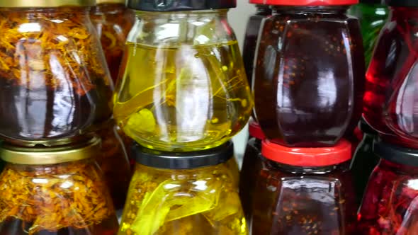 Jars of Herbal Jelly and Jam on Shelves alt