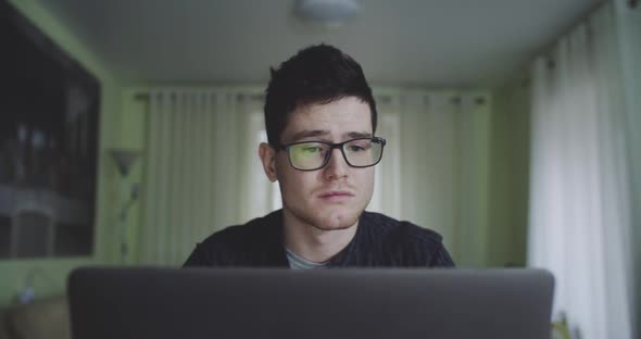 Portrait of Young Male Freelancer Deciding to Resume Working on Laptop at Home alt
