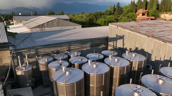 Aerial footage. Large steel barrels for wine fermentation. Wine production plant. Steel wine distill alt