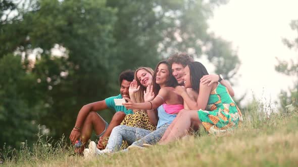 Group of friends having a great time taking selfies alt
