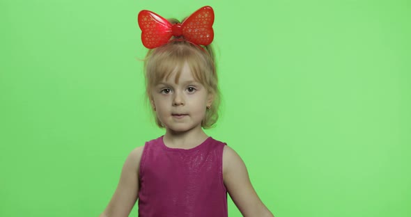 Girl in Purple Dress Dancing and Shows a Finger Forward. Happy Child. Chroma Key alt