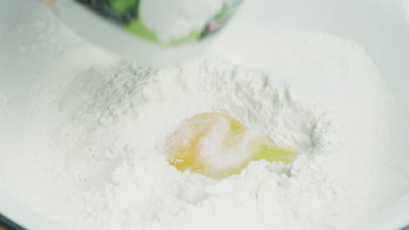 A Woman Preparing Dough in Kitchen alt