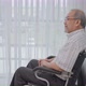 Asian senior man sitting alone on the wheelchair looking out of window - VideoHive Item for Sale