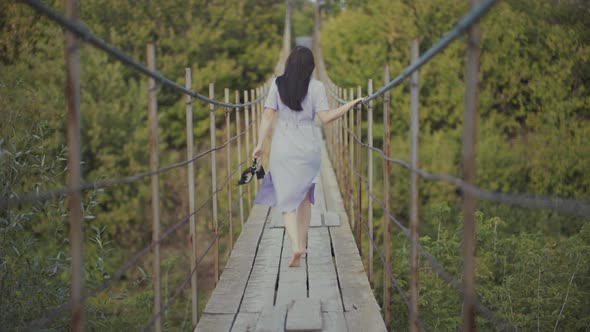 Woman in a Beautiful Dress, Runing on a Bridge in Woods alt