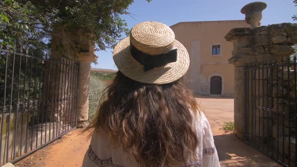 Beautiful woman walking near old luxury villa in Italy alt