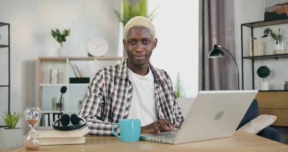 African American Gay with Blond Hair and Specific Face Expression which Looking Into Camera alt