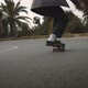 Man skates around the bend on the road, downhill, low angle gimbal shot - VideoHive Item for Sale