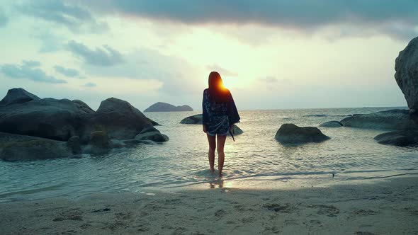 Cute Asian Girl in Kimono Walking Into the Sea at Sunset Slow Motion Thailand