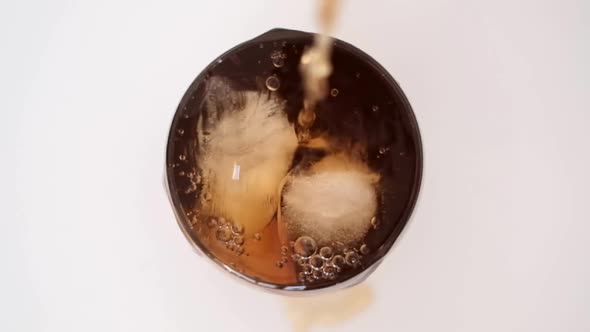 ice tea splashing from glass and ice cubes