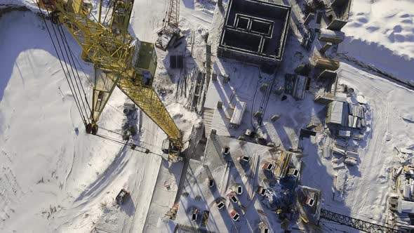Concrete residential building in the process of construction with crane alt