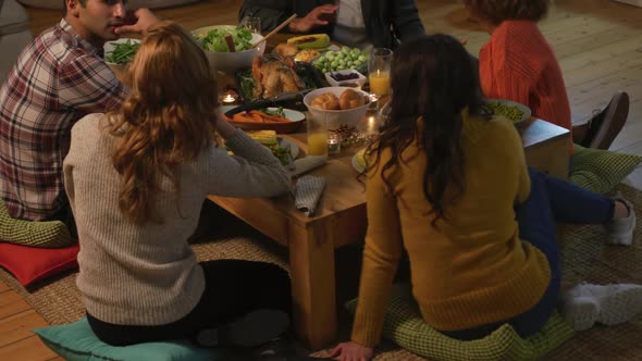 Millennial adult friends celebrating Thanksgiving together at home alt