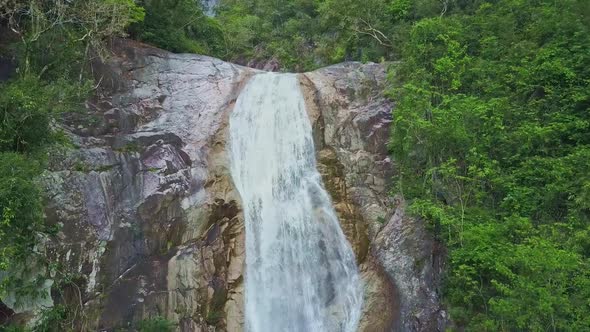 Camera Moves From Foamy Waterfall Top To Bottom alt