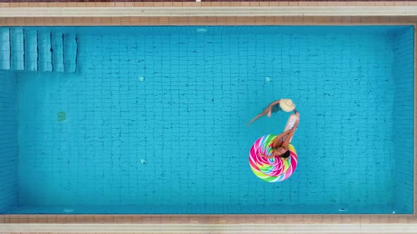 Top View of Women in Swimming Pool with Pool Float