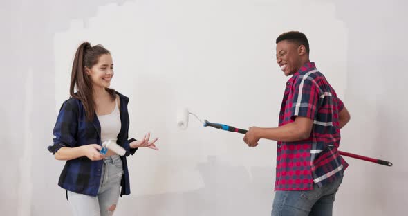 Smiling Cheerful Friends are Having Fun While Renovating Finishing Apartment Handsome Man is Fooling alt