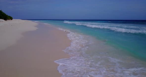 Daytime drone clean view of a summer white paradise sand beach and turquoise sea background in vibra alt