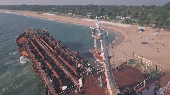 Shipwreck on a beach near Varkala in Kerala, India. Low aerial drone alt