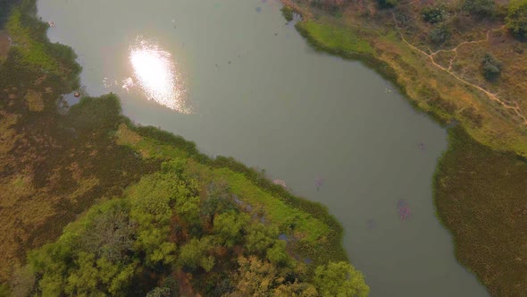 Aerial: Bangladesh river flowing through country lowlands alt