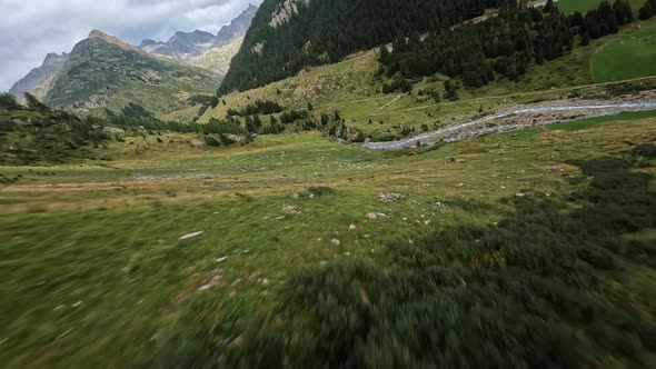 Switzerland Alp Alpine Drone Aerial Glide Fly Through and Over River alt