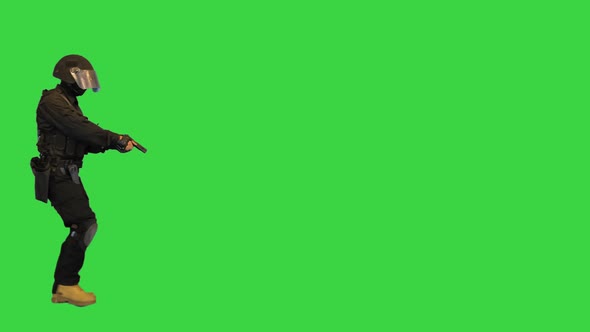 Police SWAT Armed Fighter Walking with a Hand Gun on a Green Screen Chroma Key alt