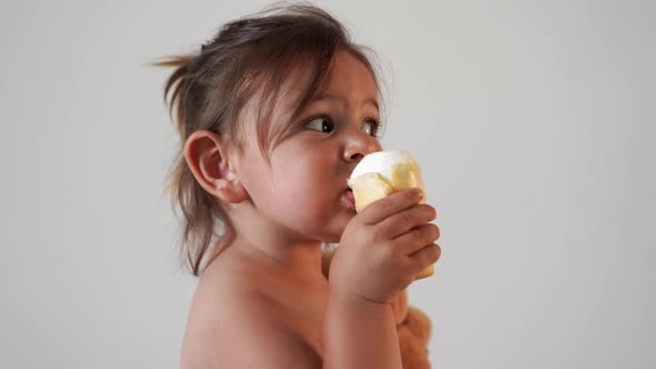Child Toddler Girl with Ice Cream at Home. Tasty Yummy Sweet Food. Funny Face alt